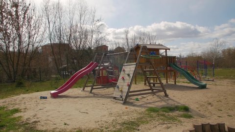 Children playground outdoors empty in quarantine autumn first snow falls camera movement
