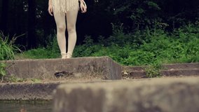Natural beauty. Beautiful female bare feet are walking on a concrete bridge.