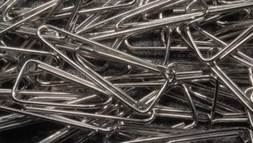 Paperclips stationery close-up. Metal consumables.