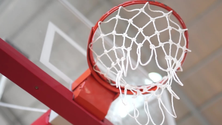 A basketball tournament. Throwing a ball in a basketball hoop. The ball gets right in target. Slow motion | Shutterstock HD Video #1060633009