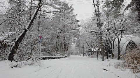 Hakuba, Japan - January 2 ,2020 : View of rural street covered with snow in Hakuba, Japan on January 2 ,2020.