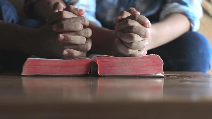 Close up hands praying on Bible at home, church in home, Home church during quarantine coronavirus Covid-19, Religion concept. Royalty-Free Stock Footage #1060639408