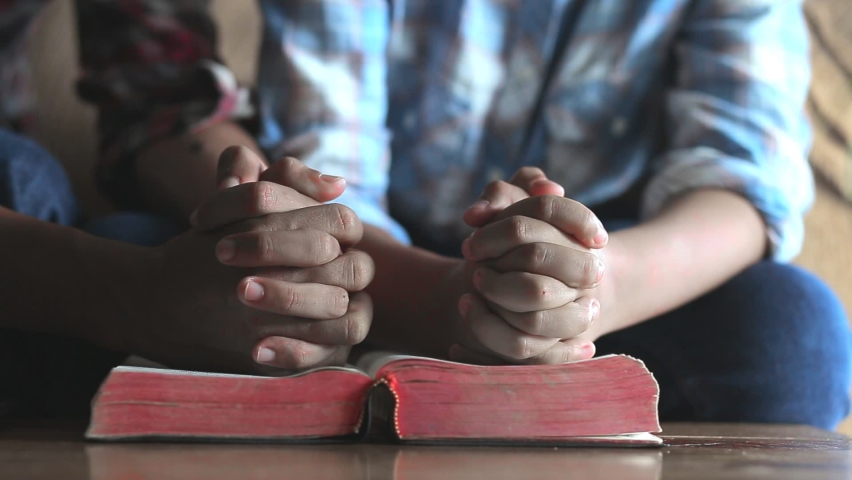 Close up hands praying on Bible at home, church in home, Home church during quarantine coronavirus Covid-19, Religion concept. | Shutterstock HD Video #1060639408