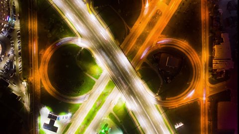 Infinity sign, Endless symbol, Eternity. Aerial top View from Above Night City Traffic. Time Lapse of Light Trails Created by Cars. Flyover Intersection in Rush Hour