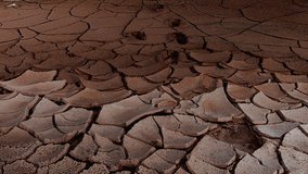Ckracked land. Red sand in the cracks. The video can be used in movies, reportage, as footage, in a music video.