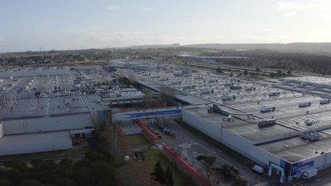 Lisbon / Portugal - 12 18 2019: Aerial, tracking, drone shot, overlooking the Volkswagen car plant, Autoeuropa manufacturing facility, on a partly sunny day, in Lisbon, Portugal