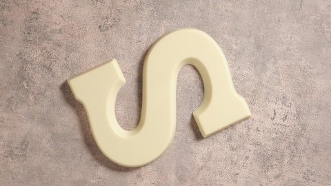 Rotation of white chocolate letter S. Background for Dutch holiday Sinterklaas. St. Nicholas day concept. FullHD video, top view