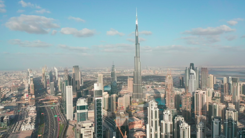 Amazing aerial view of Burj Khalifa, the world's tallest building and Downtown Dubai skyline on a cloudy day; modern futuristic city concept  Royalty-Free Stock Footage #1060660087