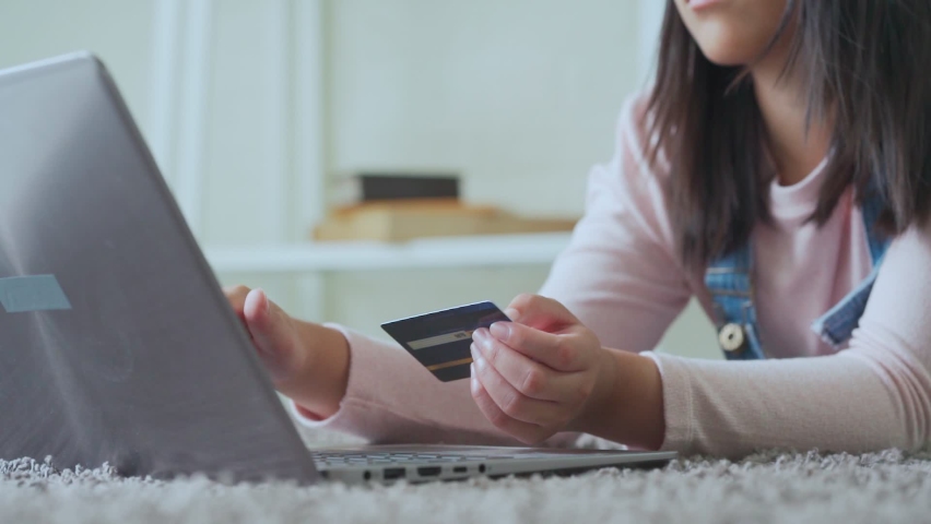 Close up young woman hold credit card use notebook computer typing number payments at home. Zoom hand girl customer purchase, shoping online food delivery, hotel booking, buy application by laptop Royalty-Free Stock Footage #1060660975