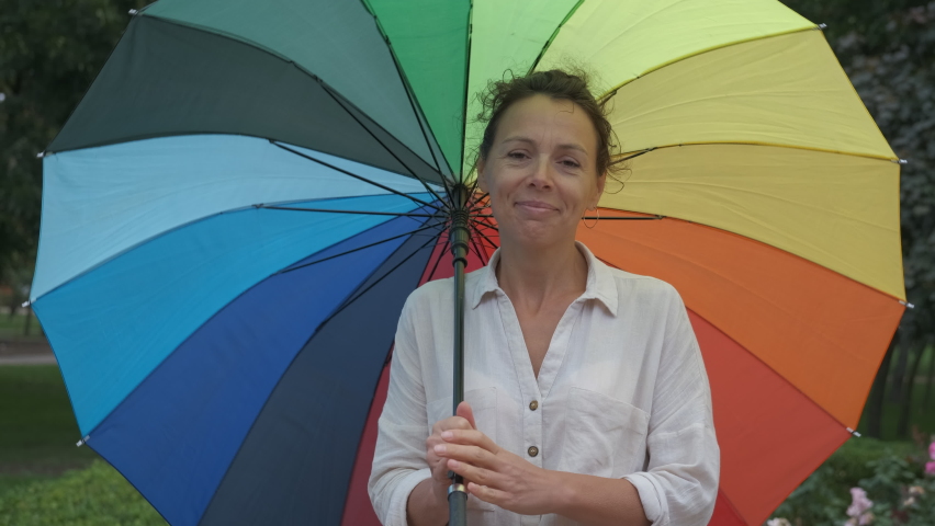 Woman with a multi-colored umbrella.