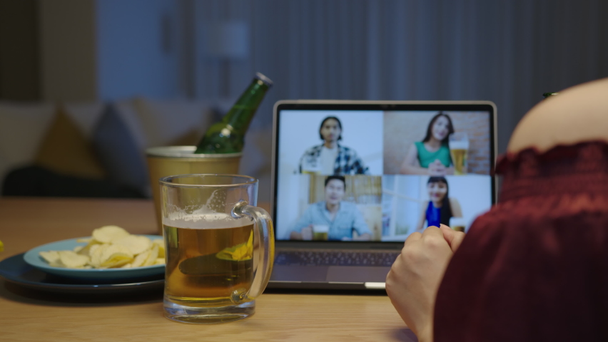 Young happy asian woman enjoy relax night party event online celebration festive with friends at home pouring beer with glass and bottle show beer foam drinking via video call. Royalty-Free Stock Footage #1060661527