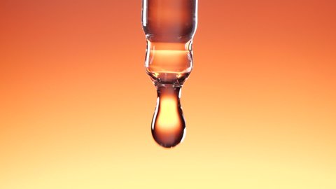 Water dropper in slow motion on orange color background