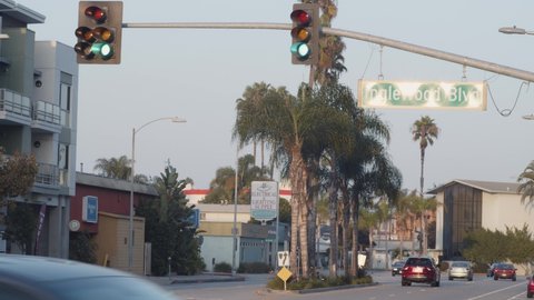 Los Angeles , CA / United States - 10 13 2020: Green traffic lights, on Inglewood Blvd with traffic, overcast day, in Los Angeles, California, USA - Static view