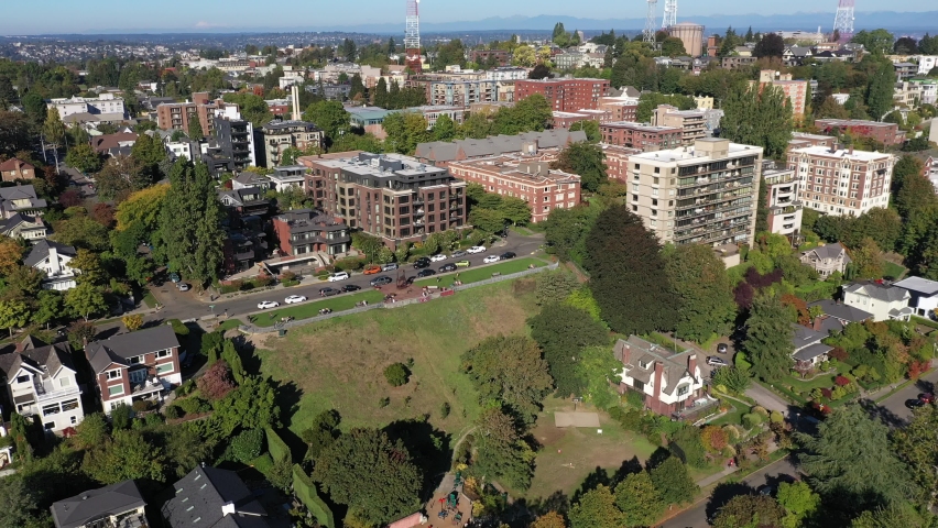 Aerial / drone footage of Kerry Park and surrounding neighborhood in Queen Anne, an upscale, affluent neighborhood uptown by Puget Sound, in Seattle, Washington