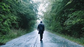 Sadness Depression Darkness Silhouette Of Sad Man Walking On Path With Trees In The Misty Mountains Loneliness Backpacking Slow Motion Drone - Powered by Shutterstock - Get 15% off with code: PIKWIZARD15