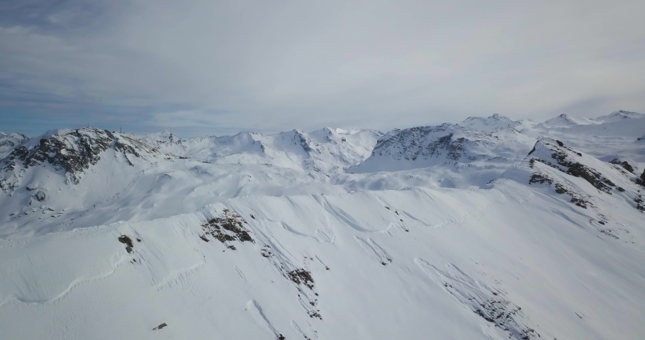 Amazing Aerial view of Ski Tin Resort French Alps Mountains covered in snow. Royalty-Free Stock Footage #1060669924