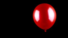 Red balloon explodes with spreading and flying golden tinsel and red stars slow motion isolated on black backdrop copy space. Festive mood, fun atmosphere, Christmas holidays concept. - Powered by Shutterstock - Get 15% off with code: PIKWIZARD15