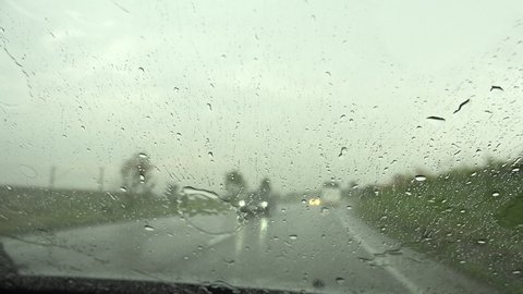 Traffic in Rain, Driving Car, Storm on the Road, Highway, Rainy Drops View on Windscreen