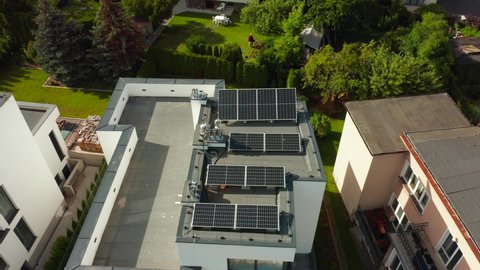 Drone shot of modern private houses with rooftop solar panels. Drone shot on a beautiful expensive village with private houses near the seashore, Gdynia, Poland.