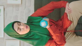 Muslim woman doing sports with equipment at home.Video for the vertical story.