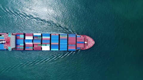 Aerial top view smart cargo ship carrying container running opposite directions for export import near  cargo yard port concept freight shipping by cargo ship .