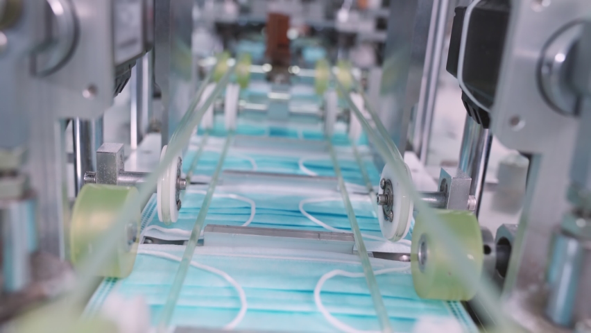 Face mask production line in modern factory . Concept of covid-19 coronavirus 2019 provention . Royalty-Free Stock Footage #1060693768