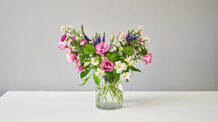 Stop motion. Bouquet 007, step by step installation of flowers in a vase. Flowers bunch, set for home. Fresh cut flowers for decoration home. European floral shop. Delivery fresh cut flower. | Shutterstock HD Video #1060696288