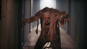 Guy in thematic bandaged costume of halloween mummy doing a funny dance in corridor, celebrating halloween - horror, halloween concept 4k footage