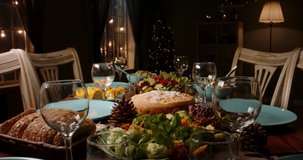 Close up shot of family dinner table with healthy organic food, set for holiday partry. Meals served on plates on table - holiday, food and drink 4k footage