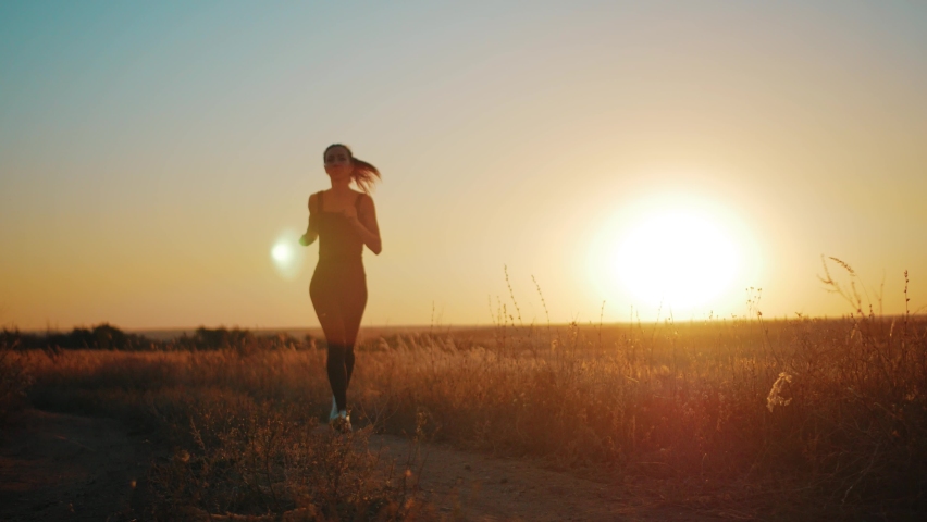Young fitness sport woman running on road at sunset. Athlete runner feet running on road, slow motion. | Shutterstock HD Video #1060704016