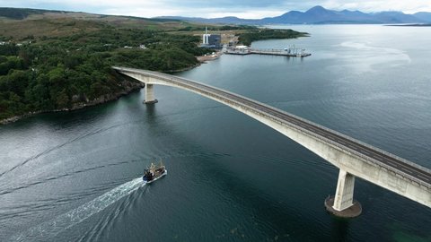 Fishing Trawlers Sailing At Loch Alsh And Passing Under The Skye Bridge With Kyleakin Plant In The Background In Scotland, United Kingdom. - aerial drone, Mavic air 2