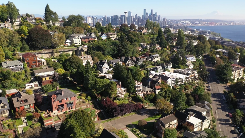 Aerial / drone footage of West Queen Anne, an upscale, affluent neighborhood uptown by Puget Sound, with the Seattle skyline and Elliott Bay in Seattle, Washington