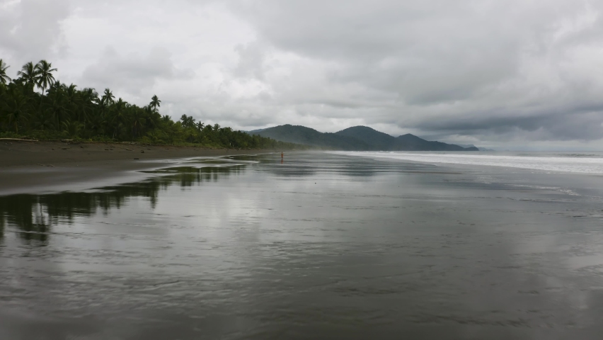 Aerial flies close over the beach and flying high up in Nuqui, Colombia.