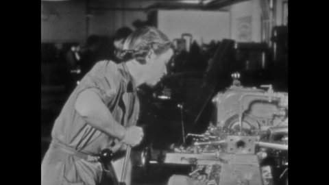 1940s ENGLAND: Men and women work in factories. Men wipes sweat from faces. Man drinks tea in factory.