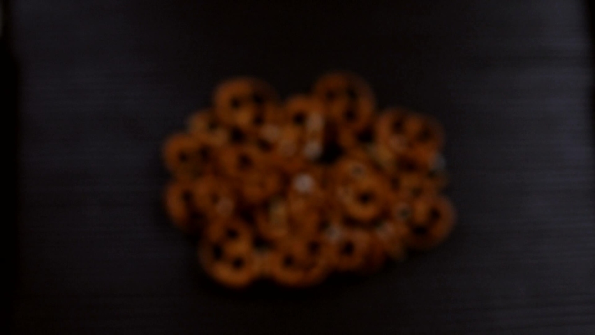 German pretzels on a dark background in super slow motion. Studio macro video