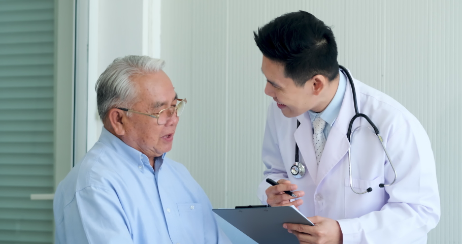 Happy Asian elderly man patient Have fun talking with professional man doctor at hospital. Old man patient talk with doctor about result of health check up report. Royalty-Free Stock Footage #1060726069