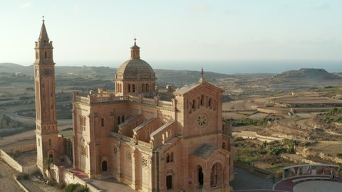 Ta Pinu Church Sand Beige Colored Basilica on Gozo, Malta in beautiful Afternoon Sunlight, Aerial dolly slide right