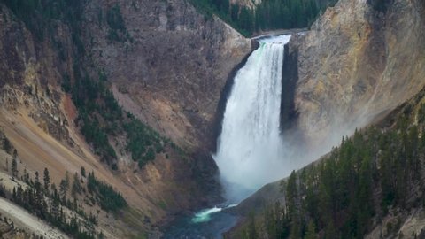 The Grand Canyon of Yellowstone National Park the lower falls thunder as mist rises above the bottom of the waterfall