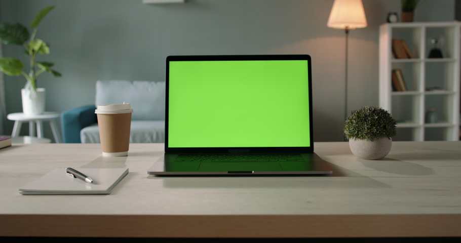 Modern laptop with mock up chroma key green screen st on desk of living room. The only template you need - remote work concept close up 4k video Royalty-Free Stock Footage #1060747372