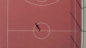 Aerial Shot of Basketball Court. Aerial view of basketball player approaching and scoring a hoop. 
 - Powered by Shutterstock - Get 15% off with code: PIKWIZARD15
