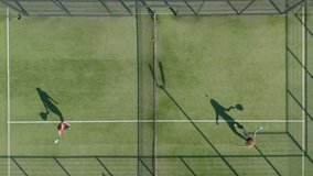 Aerial, top down, drone shot, rising above people playing tennis. 
Two girls play padl tennis - Powered by Shutterstock - Get 15% off with code: PIKWIZARD15
