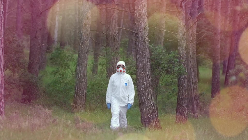 Person with a safety suit walking in a forest area. Ayegui, Navarre, Spain, Europe.