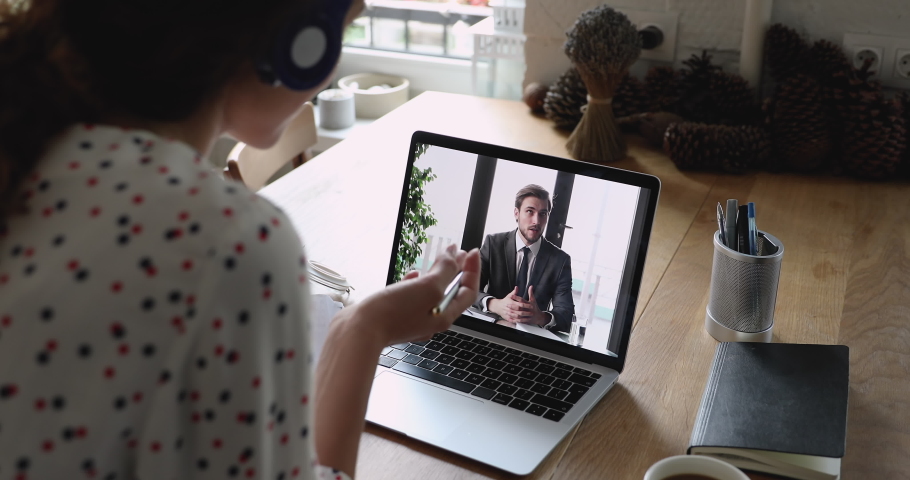 Businessman and businesswoman interact by video conference discuss project solve issues during formal distant virtual meeting, laptop monitor view over female shoulder. Job interview remotely concept | Shutterstock HD Video #1060757533