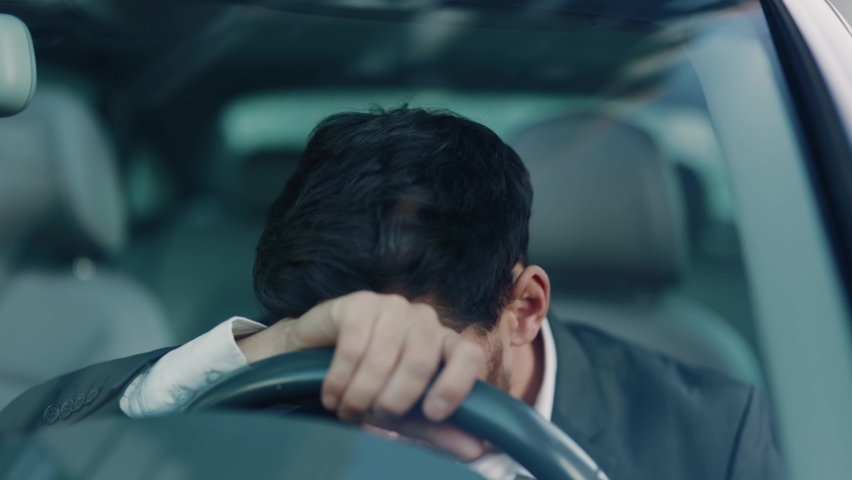 Young man sitting car in city use phone read bad news at sunlight. Feel angry stress depression. Look serious automobile. Frustrated tired. Close up. Slow motion | Shutterstock HD Video #1060757632