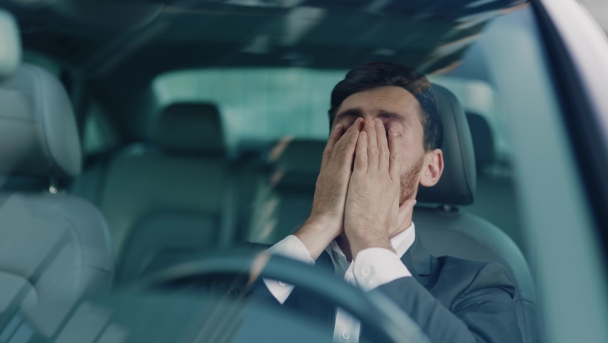 Portrait young man sitting car in city at sunlight. Feel angry stress depression. Look serious automobile. Frustrated tired. Close up. Slow motion | Shutterstock HD Video #1060757638