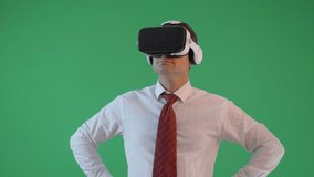 Businessman with virtual reality glasses pointing with hand, modern work, green screen