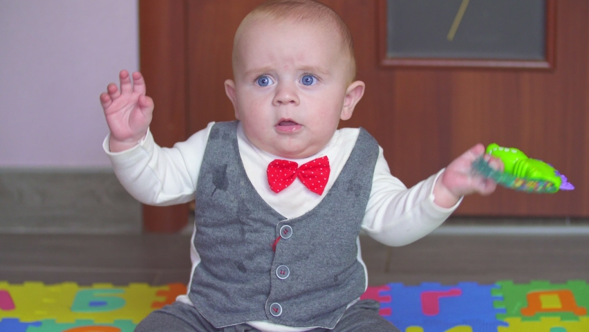 little boy playing with toys on the rug
