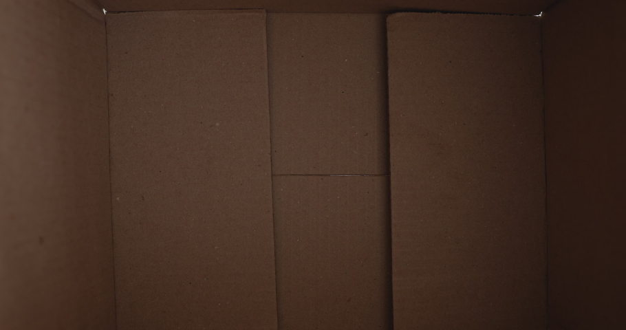 Close up inside of carton box bottom view, woman opens parcel looks at delivered goods items feels happy. Satisfied client, positive feedback. Buy in e-commerce web stores, express delivery concept Royalty-Free Stock Footage #1060760143