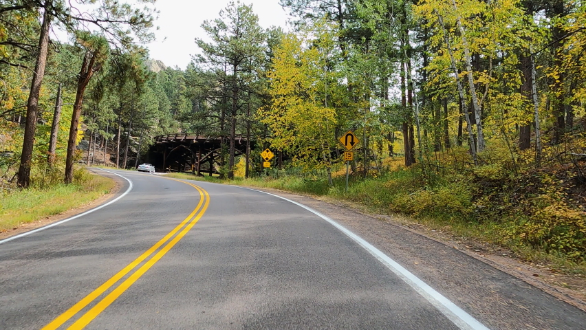 Drive historic bridge autumn Custer South Dakota POV 4K. Black Hills of South Dakota. Mountain, valley, landscape scenic discovery. State Park with wildlife, lakes, campgrounds and picnic areas.