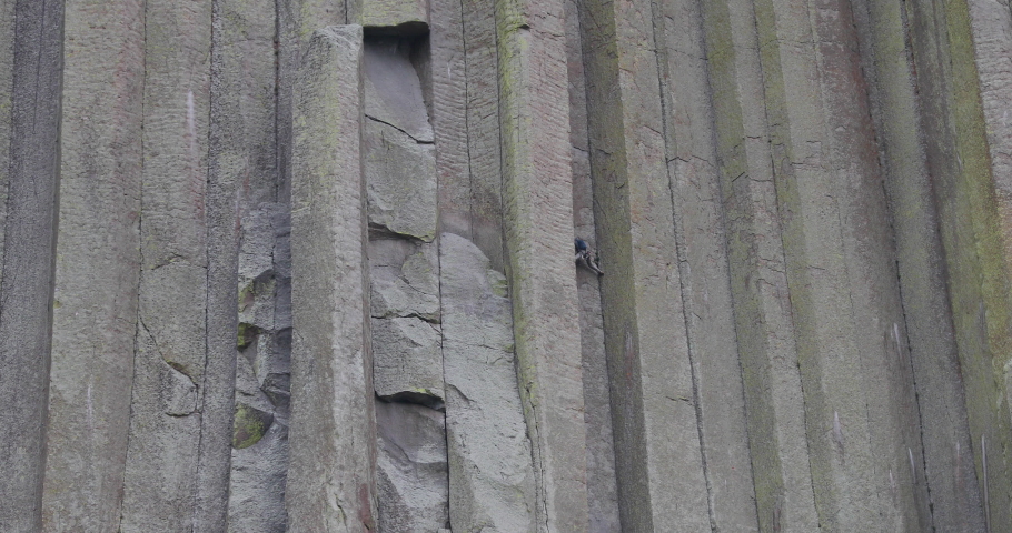 Dangerous rock climb on Devils Tower steep 4K. 1,267 feet tall igneous rock tower in Black Hills of South Dakota and Wyoming. United States National Monument. Recreation, tourism, vacation.